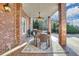 Covered outdoor dining space with brick columns and walls, a ceiling fan and BBQ grill at 4992 Price Dr, Suwanee, GA 30024