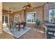 Covered patio with brick, dining table, ceiling fans, tile flooring and barbecue grill; perfect for outdoor entertaining at 4992 Price Dr, Suwanee, GA 30024