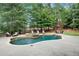 A luxurious backyard pool and spa surrounded by lush greenery and comfortable lounge seating at 4992 Price Dr, Suwanee, GA 30024