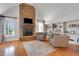 Cozy sitting area featuring a stone fireplace, built-in bookshelves, and hardwood floors at 4992 Price Dr, Suwanee, GA 30024