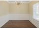 Elegant dining room showcasing classic wainscoting, modern lighting, and beautiful wood floors for sophisticated meals at 825 Donington Cir, Lawrenceville, GA 30045