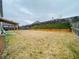 This backyard has a covered patio, a wooden fence, and a grassy area that needs work at 1159 Fort Marcy Park, Lawrenceville, GA 30044
