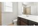 Well-lit bathroom featuring a vanity with dark brown cabinets and a tiled shower at 1159 Fort Marcy Park, Lawrenceville, GA 30044