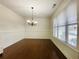 Bright dining room features hardwood floors, wainscoting, and a stylish chandelier at 1159 Fort Marcy Park, Lawrenceville, GA 30044