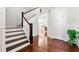Bright foyer with hardwood floors, elegant staircase, and wainscoting at 1159 Fort Marcy Park, Lawrenceville, GA 30044
