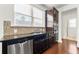 Stylish kitchen features stainless steel appliances, mosaic tile backsplash, and sleek dark countertops at 1159 Fort Marcy Park, Lawrenceville, GA 30044
