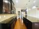 Modern kitchen featuring dark cabinets, granite countertops, and stainless steel appliances at 1159 Fort Marcy Park, Lawrenceville, GA 30044