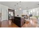 Open kitchen layout with island, dark cabinetry, and seamless flow to dining and living areas at 1159 Fort Marcy Park, Lawrenceville, GA 30044