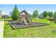 Community playground with slide and climbing structure surrounded by green grass at 1159 Fort Marcy Park, Lawrenceville, GA 30044