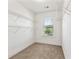 Empty walk-in closet with carpeted floors, window, and wire shelving at 1159 Fort Marcy Park, Lawrenceville, GA 30044