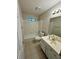 Cozy bathroom with a shower-tub combo, neutral tile, and a well-lit vanity mirror at 2020 Wynfield Point Dr, Buford, GA 30519