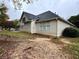 Rear exterior view highlighting the home's siding, windows, and landscape design at 2020 Wynfield Point Dr, Buford, GA 30519