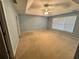 Large main bedroom with tray ceiling, a ceiling fan, and plenty of natural light at 2020 Wynfield Point Dr, Buford, GA 30519