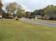 Scenic street view with lush green lawns and mature trees in a quiet residential neighborhood at 2020 Wynfield Point Dr, Buford, GA 30519