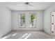 Bright bedroom with neutral carpet, a ceiling fan, and a view of the trees outside at 4100 Paces Se Walk # 3205, Atlanta, GA 30339