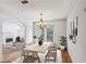 Bright dining room with chandelier, hardwood floors, and views into the living area at 4100 Paces Se Walk # 3205, Atlanta, GA 30339