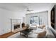 Cozy living room with a fireplace, large window, and neutral decor at 4100 Paces Se Walk # 3205, Atlanta, GA 30339
