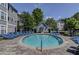 Community pool with lounge chairs surrounded by meticulously maintained landscaping near condo buildings at 4100 Paces Se Walk # 3205, Atlanta, GA 30339