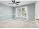 Bedroom with neutral carpet, chair rail, and a large window for natural light at 1211 Promontory Path, Marietta, GA 30062