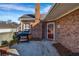 Brick backyard with barbecue and door to the house at 22107 Harvest Ridge Ln # 22, Alpharetta, GA 30022