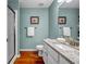 Bathroom with white cabinets, granite countertop, shower and wood look floors at 22107 Harvest Ridge Ln # 22, Alpharetta, GA 30022