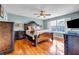 Comfortable bedroom with hard wood floors, lots of natural light, and ceiling fan at 22107 Harvest Ridge Ln # 22, Alpharetta, GA 30022