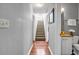 Hallway view of bathroom and stairway with wooden floors at 22107 Harvest Ridge Ln # 22, Alpharetta, GA 30022