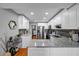 Modern kitchen features white cabinets, stainless steel appliances, granite countertops, and an open design at 22107 Harvest Ridge Ln # 22, Alpharetta, GA 30022