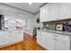 Modern kitchen featuring white cabinets, stainless steel appliances, granite countertops, and hardwood floors at 22107 Harvest Ridge Ln # 22, Alpharetta, GA 30022