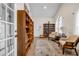 Cozy study room with a large bookshelf, two armchairs, and natural light at 22107 Harvest Ridge Ln # 22, Alpharetta, GA 30022