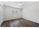 Cozy bedroom featuring a window letting in plenty of natural light and wood-look flooring at 374 Lamancha Ct, Lawrenceville, GA 30044