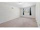 Bright bedroom has neutral walls and carpet, a window with dark curtains, and a closet at 374 Lamancha Ct, Lawrenceville, GA 30044