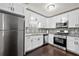 Modern kitchen featuring stainless steel appliances, granite countertops and a stylish backsplash at 374 Lamancha Ct, Lawrenceville, GA 30044
