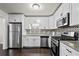 Modern kitchen featuring stainless steel appliances, granite countertops and a stylish backsplash at 374 Lamancha Ct, Lawrenceville, GA 30044