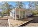 Modern home featuring a spacious wooden deck for outdoor entertaining and relaxation, surrounded by trees at 1652 Pine Cir, Austell, GA 30168