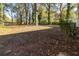 Expansive backyard featuring mature trees and plenty of open space, ideal for outdoor activities at 1652 Pine Cir, Austell, GA 30168