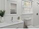 Bright bathroom featuring modern fixtures, a white vanity, and a glass-enclosed shower with a bright window at 1652 Pine Cir, Austell, GA 30168