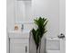 Clean bathroom featuring a white vanity, modern fixtures, and a toilet with a bright window at 1652 Pine Cir, Austell, GA 30168