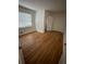 Hardwood floors and natural light fill this empty bedroom with closet at 1652 Pine Cir, Austell, GA 30168