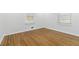 A bright, blank canvas awaits in this bedroom with hardwood floors and natural light at 1652 Pine Cir, Austell, GA 30168