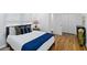 Inviting bedroom with wood floors, closet, bright window, side table with lamp, and a comfortable interior design at 1652 Pine Cir, Austell, GA 30168