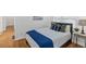 Cozy bedroom featuring a bright window, wood floors, side table with lamp, and a relaxing interior design at 1652 Pine Cir, Austell, GA 30168