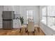 Well-lit dining area features hardwood floors, a glass table, and large windows at 1652 Pine Cir, Austell, GA 30168