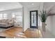 Bright foyer with hardwood floors, stylish front door, and an open view into the living room at 1652 Pine Cir, Austell, GA 30168