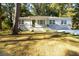 Inviting single-story home with a well-manicured lawn, brick foundation, and cozy front porch at 1652 Pine Cir, Austell, GA 30168