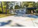Charming single-story home with a long driveway and carport, nestled among mature trees at 1652 Pine Cir, Austell, GA 30168