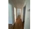 Bright hallway featuring wood floors and neutral walls, leading to other rooms in the home at 1652 Pine Cir, Austell, GA 30168