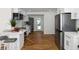 Modern kitchen featuring white cabinets, hardwood floors, and stainless steel appliances at 1652 Pine Cir, Austell, GA 30168