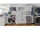 Contemporary kitchen with white cabinets, stainless steel appliances, and a laundry area at 1652 Pine Cir, Austell, GA 30168