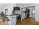 Open-concept kitchen with a breakfast bar, stainless steel appliances, and wood floors at 1652 Pine Cir, Austell, GA 30168